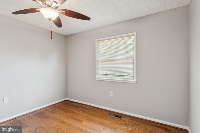 9405 Loughran Rd, Fort Washington, MD 20744 - unfurnished room with wood finished floors, ceiling fan, and a textured ceiling