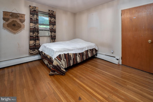 3221 Union Ave, Pennsauken, NJ 08109 - bedroom featuring a baseboard radiator, wood finished floors, and cooling unit