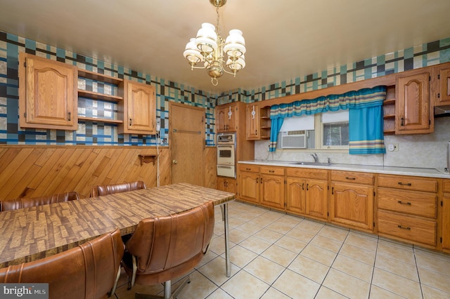 3221 Union Ave, Pennsauken, NJ 08109 - kitchen with open shelves, a chandelier, and stainless steel oven