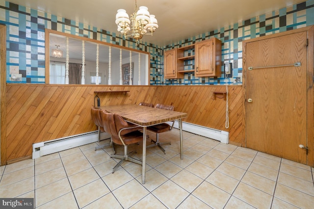 3221 Union Ave, Pennsauken, NJ 08109 - dining area featuring a baseboard radiator, a chandelier, light tile patterned flooring, wallpapered walls, and wood walls