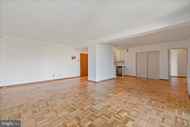 2475 Virginia Ave NW Unit 600, Washington, DC 20037 - unfurnished living room featuring baseboards