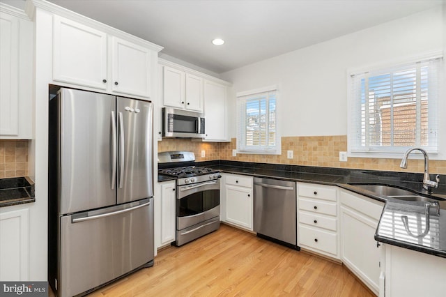19 Yogurt Ln, Baltimore, MD 21231 - kitchen with appliances with stainless steel finishes, white cabinetry, recessed lighting, backsplash, and light wood finished floors