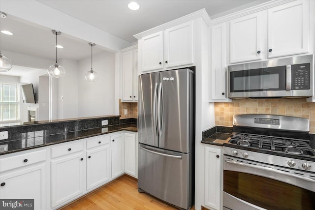 19 Yogurt Ln, Baltimore, MD 21231 - kitchen with appliances with stainless steel finishes, white cabinets, tasteful backsplash, decorative light fixtures, and recessed lighting