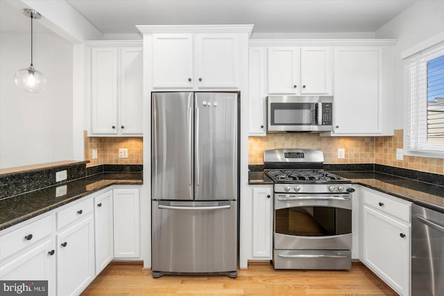19 Yogurt Ln, Baltimore, MD 21231 - kitchen with appliances with stainless steel finishes, white cabinetry, dark stone counters, and tasteful backsplash