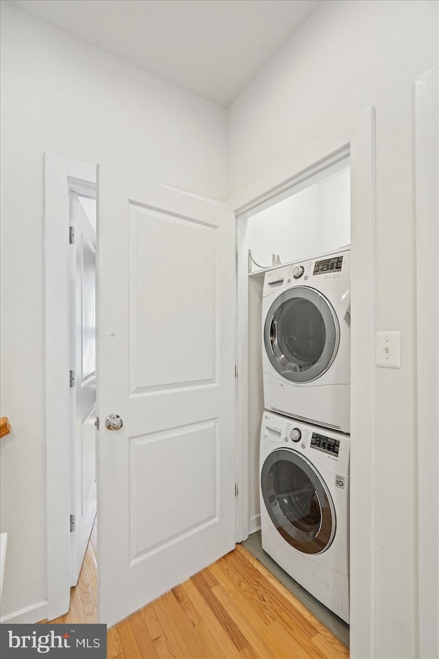 19 Yogurt Ln, Baltimore, MD 21231 - washroom with stacked washer and clothes dryer and light wood finished floors