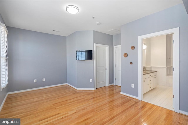 19 Yogurt Ln, Baltimore, MD 21231 - unfurnished bedroom with light wood-type flooring and ensuite bathroom
