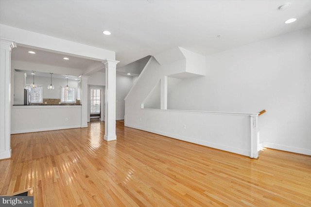 19 Yogurt Ln, Baltimore, MD 21231 - unfurnished living room with light wood-style floors, decorative columns, and recessed lighting