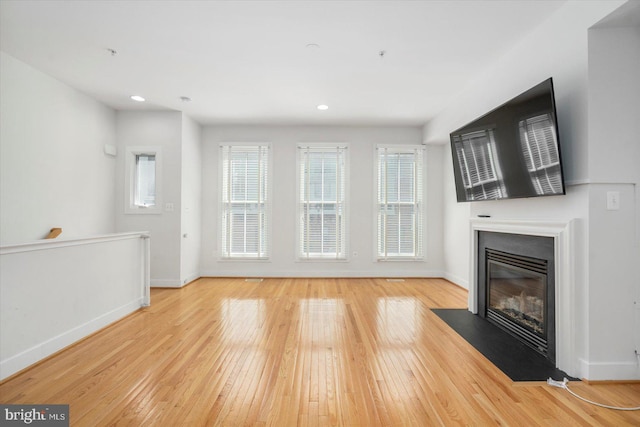 19 Yogurt Ln, Baltimore, MD 21231 - unfurnished living room featuring a fireplace with flush hearth, hardwood / wood-style flooring, and recessed lighting