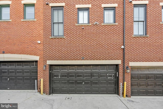 19 Yogurt Ln, Baltimore, MD 21231 - view of side of home featuring brick siding and an attached garage