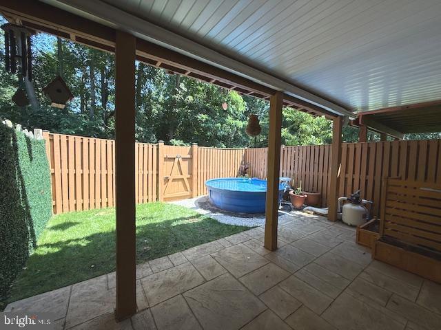 3328 Pescara Ct, Pasadena, MD 21122 - fenced backyard with a patio