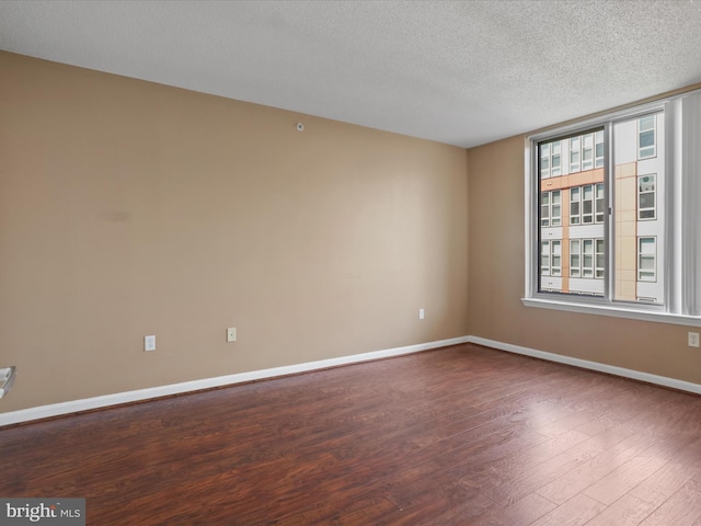 2726 Gallows Rd Unit 411, Vienna, VA 22180 - spare room featuring wood finished floors and a textured ceiling