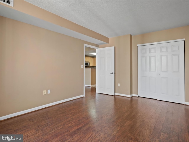 2726 Gallows Rd Unit 411, Vienna, VA 22180 - unfurnished bedroom with wood finished floors, a textured ceiling, and a closet