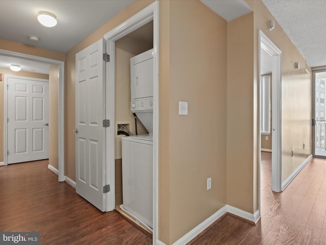 2726 Gallows Rd Unit 411, Vienna, VA 22180 - hallway featuring stacked washing machine and dryer and wood finished floors