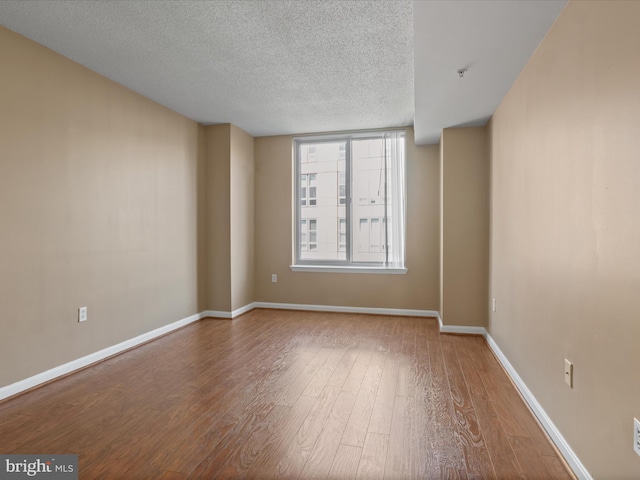 2726 Gallows Rd Unit 411, Vienna, VA 22180 - empty room with wood-type flooring and a textured ceiling