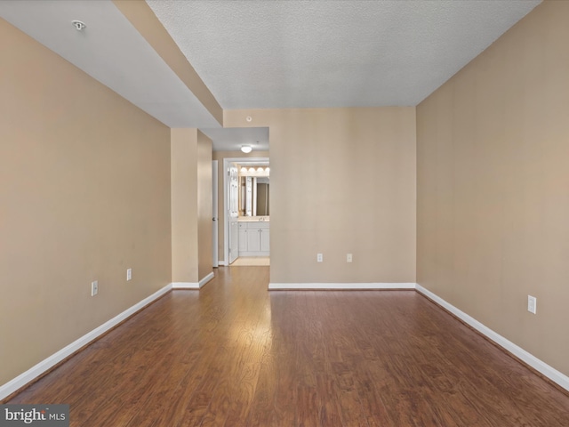 2726 Gallows Rd Unit 411, Vienna, VA 22180 - spare room with wood finished floors, a pendent fire sprinkler, and a textured ceiling