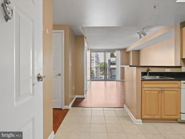 2726 Gallows Rd Unit 411, Vienna, VA 22180 - kitchen featuring dark countertops, light tile patterned flooring, dishwasher, and open floor plan