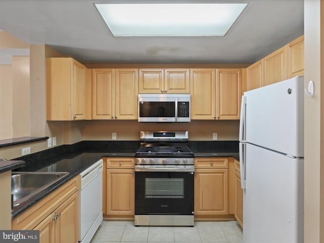 2726 Gallows Rd Unit 411, Vienna, VA 22180 - kitchen with appliances with stainless steel finishes, light brown cabinets, light tile patterned flooring, and dark stone counters