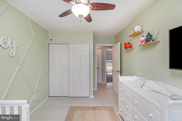 9523 Hickory Falls Way, Baltimore, MD 21236 - bedroom featuring light wood-type flooring, a closet, a decorative wall, and ceiling fan
