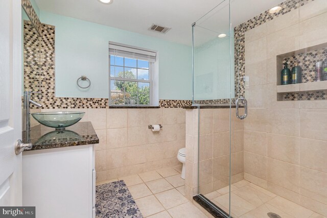 9523 Hickory Falls Way, Baltimore, MD 21236 - bathroom featuring tile walls, tile patterned floors, a stall shower, vanity, and recessed lighting