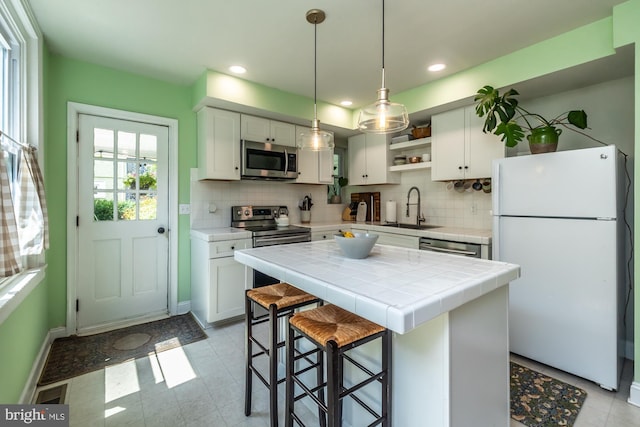239 W Barnard St, West Chester, PA 19382 - kitchen featuring stainless steel appliances, open shelves, white cabinetry, tile countertops, and recessed lighting