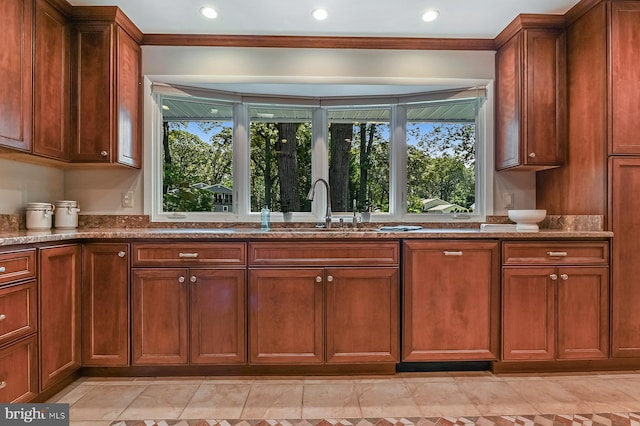 10 Sonora Dr, Pasadena, MD 21122 - kitchen with stone countertops, brown cabinets, recessed lighting, light tile patterned floors, and ornamental molding