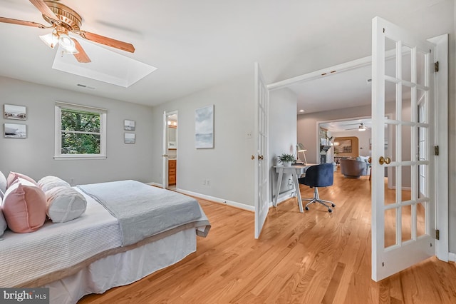 10 Sonora Dr, Pasadena, MD 21122 - bedroom with a skylight, light wood-style flooring, an office area, and a ceiling fan