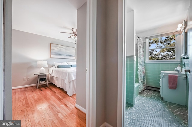 10 Sonora Dr, Pasadena, MD 21122 - ensuite bathroom featuring shower / bath combination with curtain, tile walls, a ceiling fan, and wood finished floors