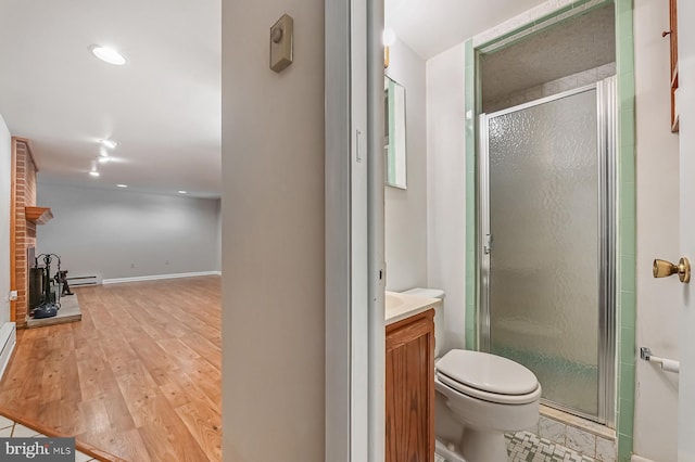 10 Sonora Dr, Pasadena, MD 21122 - bathroom featuring vanity, a shower stall, wood finished floors, a baseboard radiator, and recessed lighting
