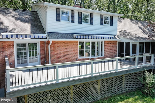 10 Sonora Dr, Pasadena, MD 21122 - back of house featuring brick siding, a wooden deck, roof with shingles, and a chimney