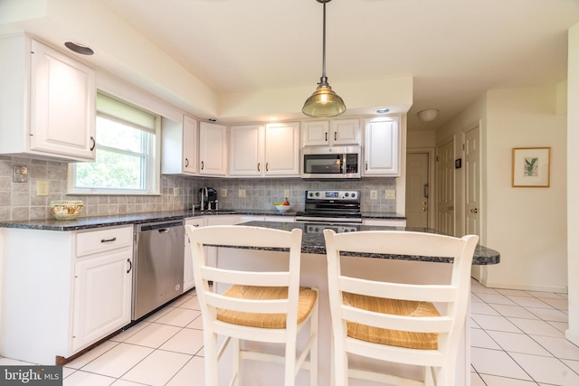 14 Winslow Way, Dresher, PA 19025 - kitchen featuring stainless steel appliances, light tile patterned floors, white cabinets, and decorative backsplash
