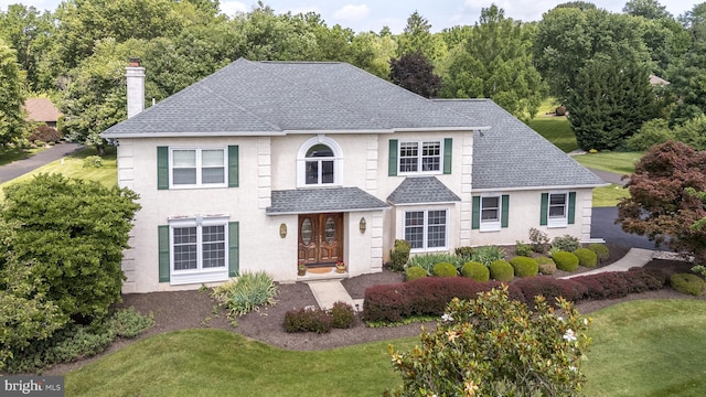 14 Winslow Way, Dresher, PA 19025 - view of front of property with a chimney, roof with shingles, stucco siding, and a front lawn