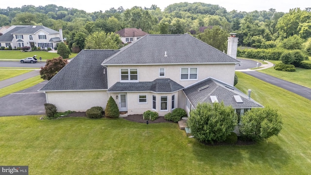 14 Winslow Way, Dresher, PA 19025 - back of property featuring stucco siding, a chimney, a lawn, and roof with shingles