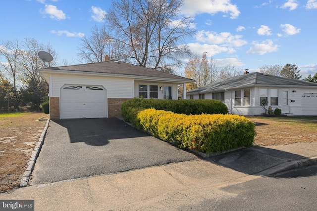 321 Curacao St, Toms River, NJ 08757 - view of front of property featuring brick siding, driveway, a garage, and a chimney