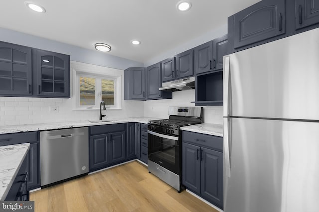 321 Curacao St, Toms River, NJ 08757 - kitchen featuring stainless steel appliances, under cabinet range hood, light stone counters, tasteful backsplash, and light wood-style floors