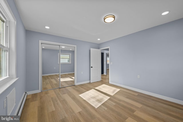 321 Curacao St, Toms River, NJ 08757 - unfurnished bedroom with a baseboard radiator, light wood-type flooring, a closet, and recessed lighting