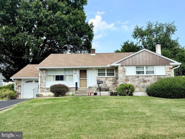 147 Richard Rd, Aston, PA 19014 - single story home with stone siding, a chimney, a front lawn, board and batten siding, and a garage
