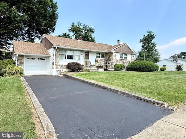 147 Richard Rd, Aston, PA 19014 - single story home featuring stone siding, a garage, a chimney, driveway, and a front lawn
