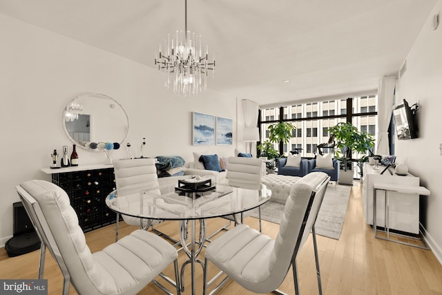 1010 Massachusetts Ave NW Unit 706, Washington, DC 20001 - dining area with light wood-style floors, a chandelier, and floor to ceiling windows