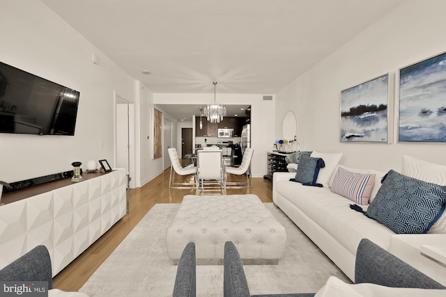 1010 Massachusetts Ave NW Unit 706, Washington, DC 20001 - living area with a chandelier and light wood-style floors