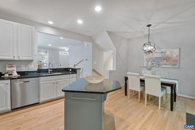 834 Rock Creek Rd, Charlottesville, VA 22903 - kitchen with stainless steel dishwasher, white cabinetry, dark stone counters, light wood-type flooring, and a center island