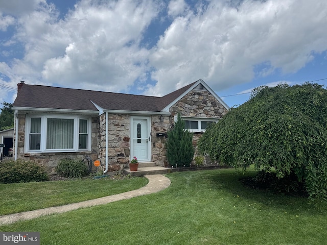 2008 Cullum Dr, Reading, PA 19601 - view of front of home with stone siding, a front yard, a shingled roof, and a chimney