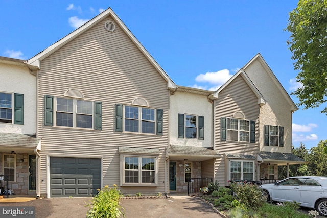 723 Dell Ct, Southampton, PA 18966 - townhome / multi-family property featuring stone siding, an attached garage, and asphalt driveway