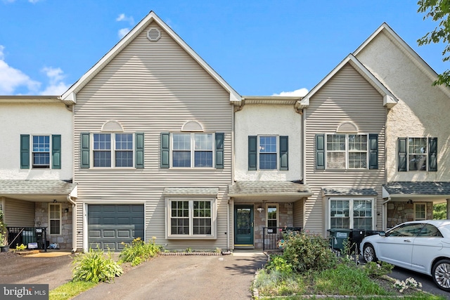 723 Dell Ct, Southampton, PA 18966 - multi unit property with stone siding, a garage, asphalt driveway, and stucco siding