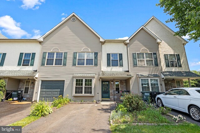 723 Dell Ct, Southampton, PA 18966 - townhome / multi-family property featuring stone siding, driveway, and an attached garage