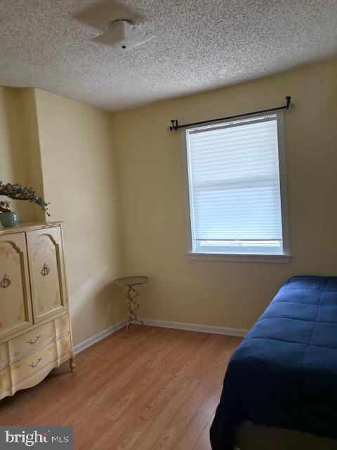 2642 S 17th St, Philadelphia, PA 19145 - bedroom with a textured ceiling and light wood-style flooring