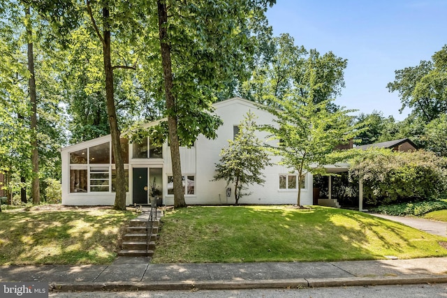2103 Northcliff Dr, Baltimore, MD 21209 - view of front of house with a front lawn, a sunroom, and concrete driveway