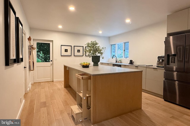 2103 Northcliff Dr, Baltimore, MD 21209 - kitchen with fridge with ice dispenser, modern cabinets, a kitchen island, light wood-style flooring, and recessed lighting