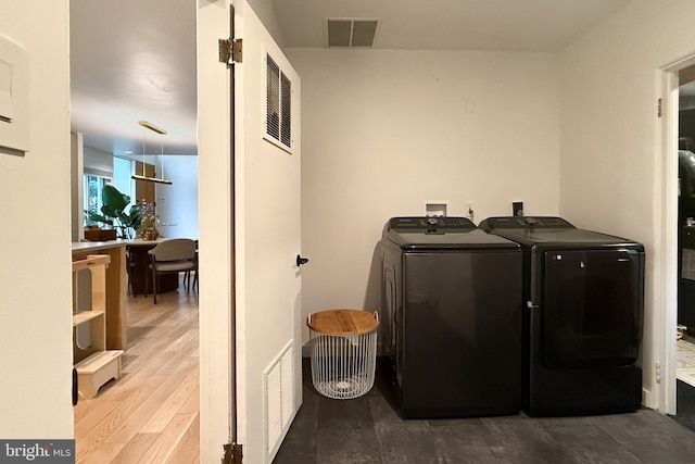 2103 Northcliff Dr, Baltimore, MD 21209 - washroom featuring separate washer and dryer and wood finished floors