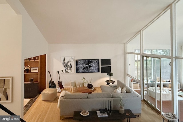 2103 Northcliff Dr, Baltimore, MD 21209 - living area with wood finished floors, a high ceiling, and floor to ceiling windows
