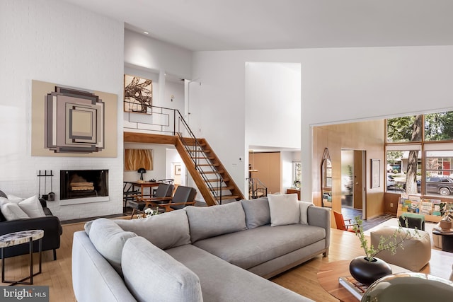 2103 Northcliff Dr, Baltimore, MD 21209 - living area featuring a towering ceiling, stairway, a fireplace, and light wood finished floors
